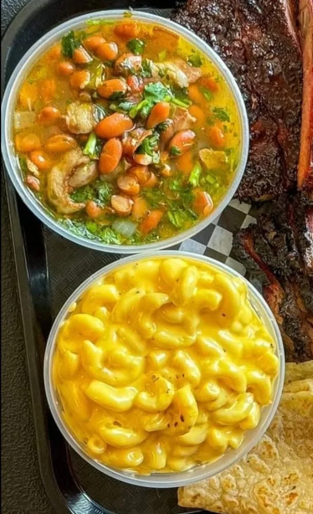 Beans and macaroni beside smoked meats on the official Vargas BBQ tray